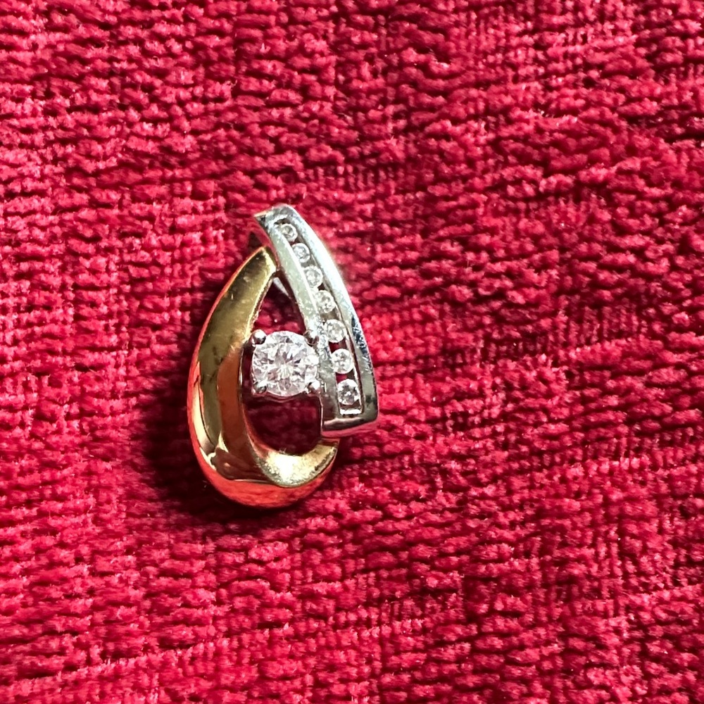 The center diamond is .33 kts. 
It’s two tone gold. 14 kt. From Kay jewelers